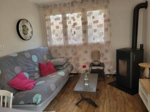 a living room with a couch and a table at appartement leauma in Guillestre