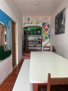 a white table in a room with a colorful wall at Jahospedaria & Ecoturismo in Lençóis