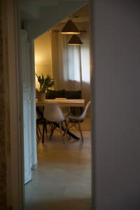 a dining room with a table and chairs in a room at Langhem Suites Luxury Apartments in Castiglione Falletto