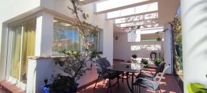 a room with a table and chairs on a balcony at Tabarca - Chalet con jardín y piscina comunitaria in Peniscola