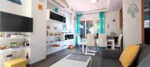 a living room with a couch and a dining room at Tabarca - Chalet con jardín y piscina comunitaria in Peniscola +82 photos