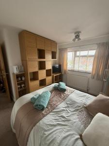 a bedroom with a large bed with towels on it at 16 Bentley Road - Uttoxeter, Comfortable accommodations, SHARED SHOWER ROOM, NO BREAKFAST in Uttoxeter