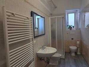 a bathroom with a sink and a toilet at RB Della Torre in Porretta Terme +23 photos
