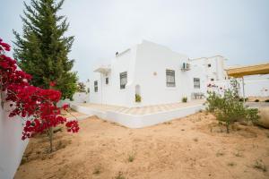 a white house with a christmas tree in front of it at Villa Bianca 2 in Fafou
