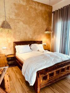 a bedroom with a large bed with a wooden frame at Lala salama Kendwa villas in Kendwa +29 photos