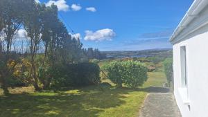a view of a garden from the side of a house at Teach Eamonn in Annagry