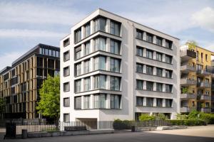 an apartment building in front of two buildings at Bob W Munich City West in Munich