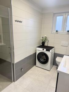 a bathroom with a washing machine and a toilet at Apartments Luna in Dramalj +46 photos