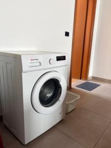 a washing machine sitting next to a door at Guest House by Roni in Durrës