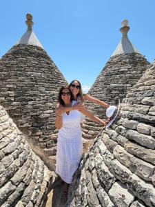 two women standing on the roof of a building at Luxury Trulli di Giulia, exclusive villa with private pool in Valle d'Itria Ostuni - BR, Puglia in Ostuni