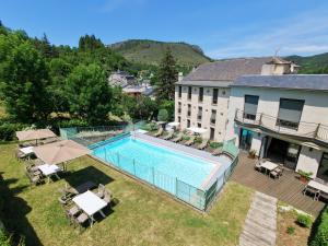 an aerial view of a hotel with a swimming pool at Logis Hôtel Restaurant Le Mont Aigoual in Meyrueis