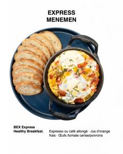 a skillet with eggs and bread on a plate at Hola Luxury Appart in Dakhla
