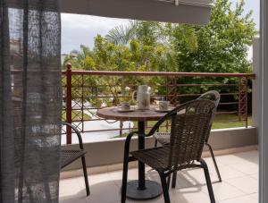 a table and chairs sitting on a balcony with a view at Dion Zois in Finikounta