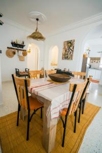 a dining room with a wooden table and chairs at Villa Bianca 2 in Fafou