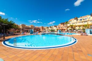 a swimming pool in the middle of a resort at OBSIDIAN Granada Park in Arona