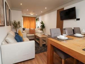 a living room with a table and a dining room at Steam and Stay Hoole in Chester