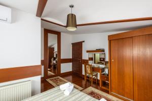 a bedroom with a bed and a room with a desk at Boutique Hotel 89 in Peje +17 photos