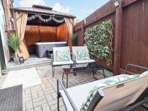 two chairs and a table on a patio at Steam and Stay Hoole in Chester
