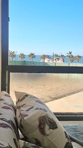 a couch with a view of the beach from a window at 2bed rooms chalet portosaid in Port Said