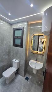 a bathroom with a toilet and a sink at 2bed rooms chalet portosaid in Port Said +14 photos