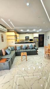 a living room with a couch and a table at 2bed rooms chalet portosaid in Port Said