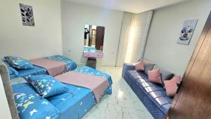 a living room with two beds and a couch at 2bed rooms chalet portosaid in Port Said
