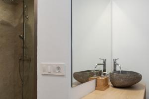 a bathroom with two sinks and a mirror at Boomerang Sea View Accommodation in Planos