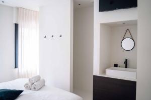 a bedroom with a bed with a sink and a mirror at Vakantiewoning number 44 in Ieper