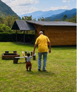 a man and a child walking in the grass at San Marcos Mountain Lodge in Chontabamba +7 photos