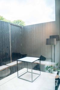 a glass table sitting on top of a balcony at Vakantiewoning number 44 in Ieper