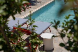 an overhead view of two chairs and a swimming pool at Soleil Hotel Paros in Drios