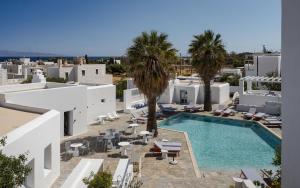 an aerial view of a hotel with a swimming pool and palm trees at Soleil Hotel Paros in Drios