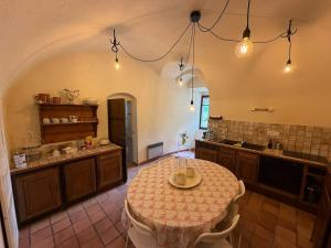 a large kitchen with a table in a room at Château de Savigny - Suite Terre in Savigny