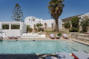 a villa with a swimming pool and a house at Soleil Hotel Paros in Drios