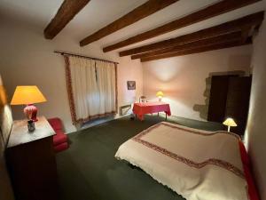 a bedroom with a bed and a red table at Château de Savigny - Suite Terre in Savigny