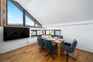 a dining room with a table and chairs at Aspen Lodge Apartments & Sauna in Černý Dŭl
