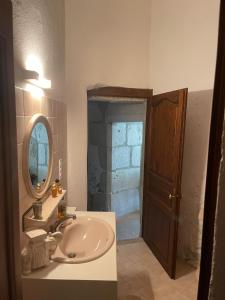 a bathroom with a sink and a mirror at Château de Savigny - Suite Terre in Savigny