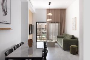 a living room with a table and a couch at דקוטה 11 Dakota in Eilat