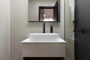 a bathroom with a white sink and a mirror at דקוטה 11 Dakota in Eilat +20 photos
