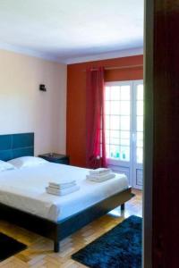a bedroom with a bed and a large window at Casa de Alvite in Alvito +30 photos