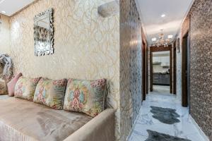 a living room with a couch and a wall at Gated oceanfront residence - chic apartment in Salé