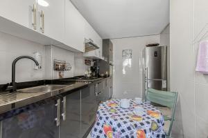 a small kitchen with a table and a refrigerator at Gated oceanfront residence - chic apartment in Salé +17 photos