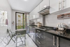 a kitchen with a stove and a counter top at Gated oceanfront residence - chic apartment in Salé