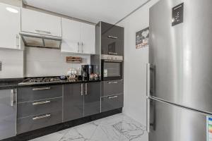 a kitchen with stainless steel appliances and a refrigerator at Gated oceanfront residence - chic apartment in Salé