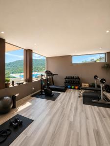 a gym with a large window and exercising equipment at Lake View Apartament 39 - Free Parking & Terrace in Cadegliano Viconago