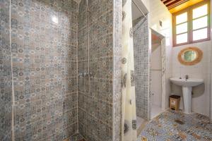 a bathroom with a shower and a sink at Riad Lik in Fez