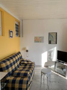 a living room with a couch and a table at Lascar in Royan