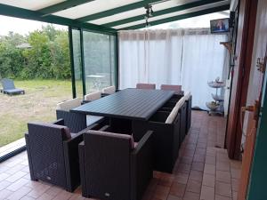 a dining room with a table and chairs at Maison de Campagne Les Oyats in Quend