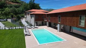an overhead view of a swimming pool next to a house at Villa Lijó Suites in Rio Caldo