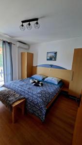 a bedroom with a bed with shoes on it at Apartman Rab Blue in Rab